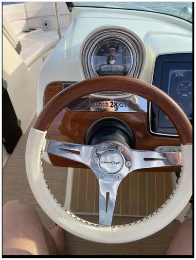  Yacht Photos Pics Steering wheel and dashboard of a 2021 Chris-Craft 28 Launch GT boat.