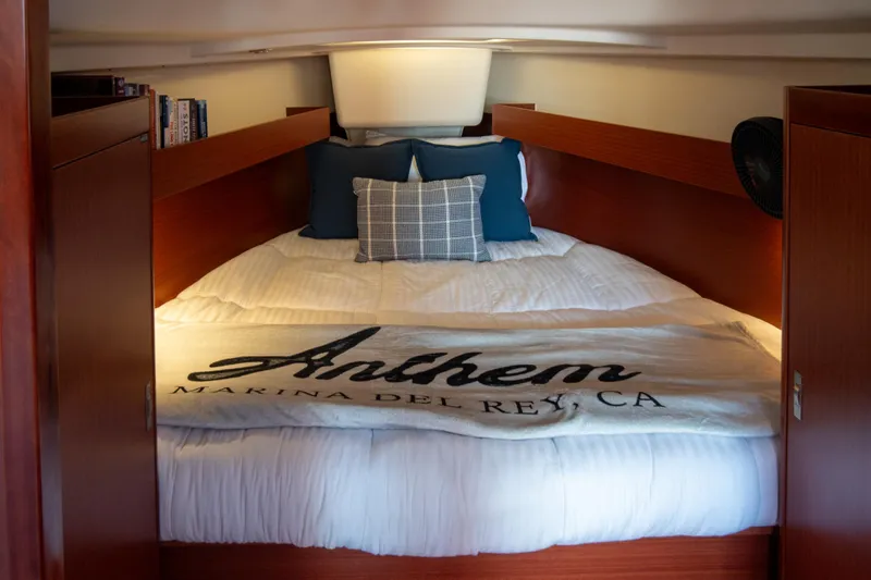 Anthem Yacht Photos Pics Cozy cabin interior of 2022 Dehler 34 yacht with plush bedding and pillows.