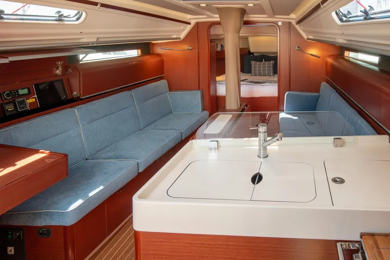 Anthem Yacht Photos Pics Luxurious interior of 2022 Dehler 34 yacht with modern seating and kitchen area.