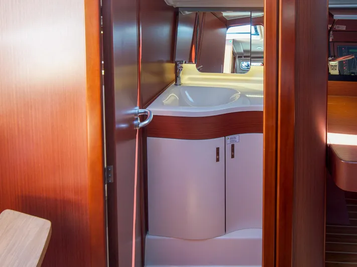 Anthem Yacht Photos Pics Interior of 2022 Dehler 34 yacht, featuring a compact bathroom with wooden finishes.