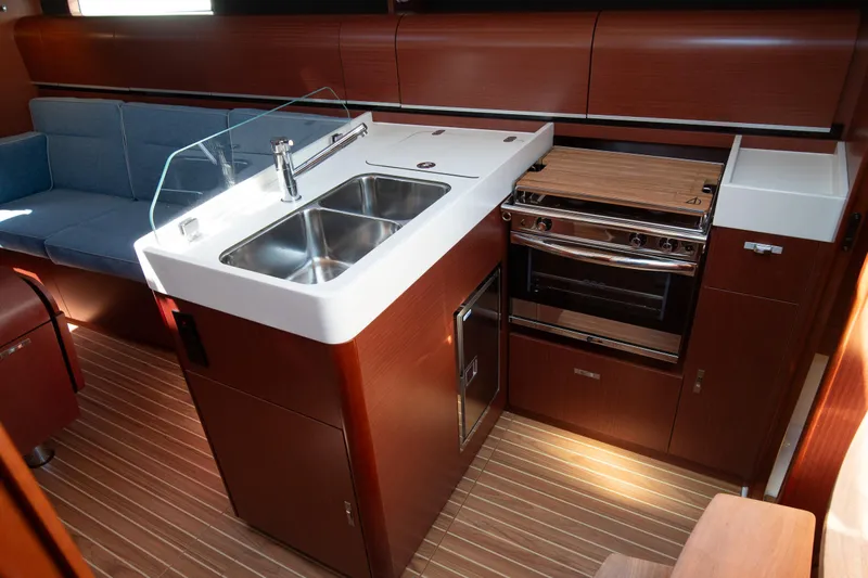 Anthem Yacht Photos Pics 2022 Dehler 34 yacht interior with modern kitchen and sleek wood finish.