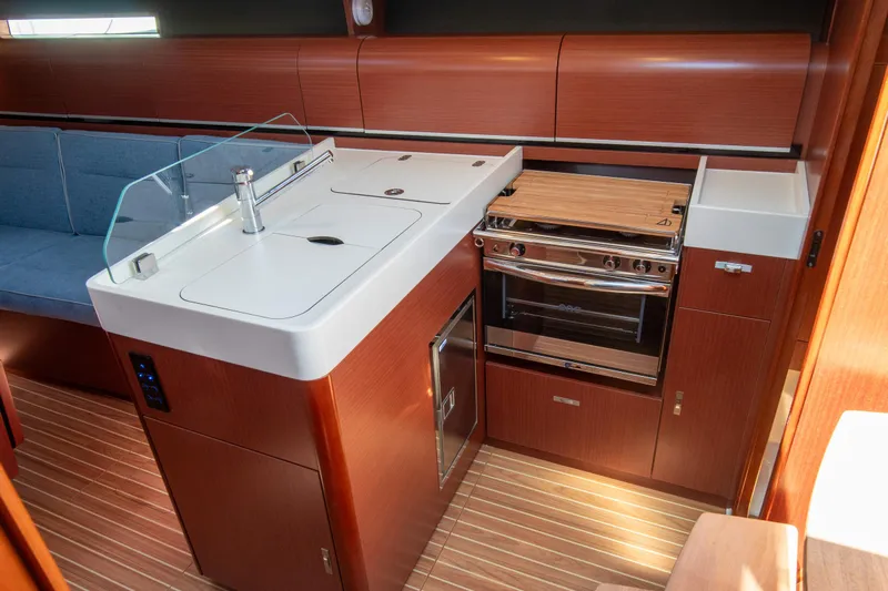 Anthem Yacht Photos Pics Modern kitchen interior of 2022 Dehler 34 yacht with sleek wood finish.