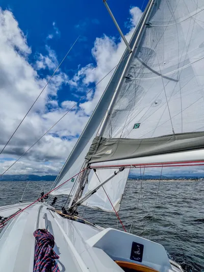 Anthem Yacht Photos Pics 2022 Dehler 34 sailboat navigating under clear skies and calm waters.