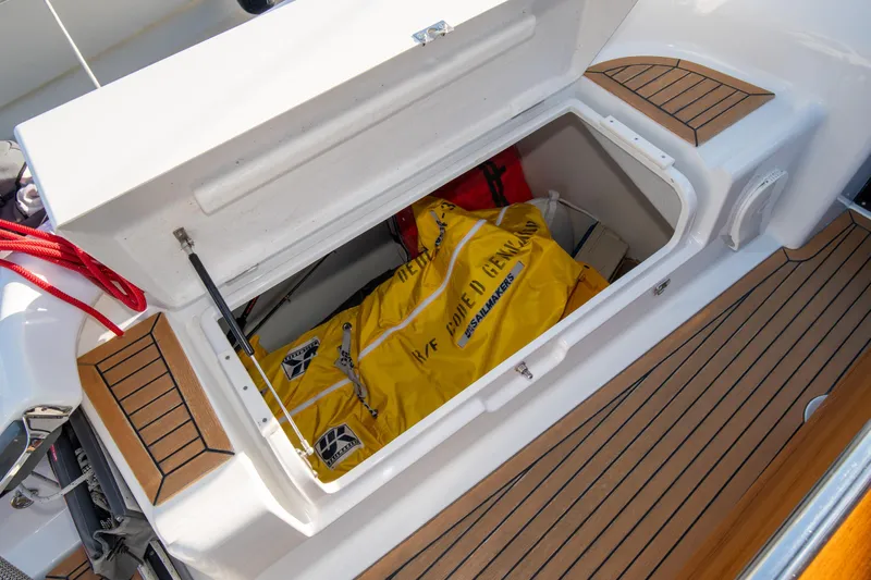 Anthem Yacht Photos Pics 2022 Dehler 34 yacht storage compartment with yellow safety equipment.