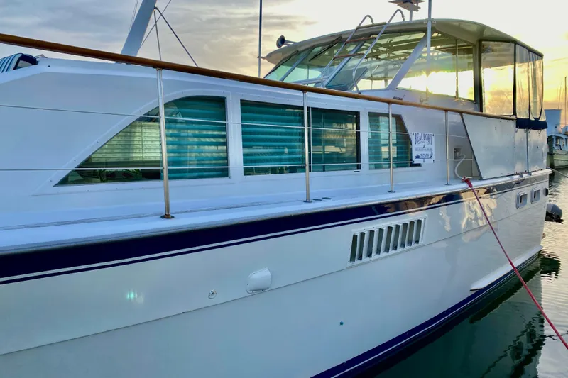 Lazy Livin' Yacht Photos Pics 1971 Hatteras 43 Double Cabin yacht docked at sunset, side view.