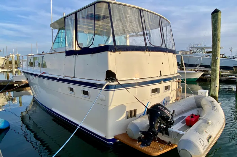 Lazy Livin' Yacht Photos Pics 1971 Hatteras 43 Double Cabin yacht docked with inflatable boat attached.