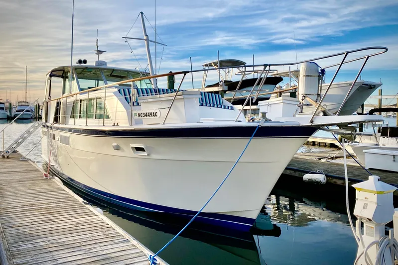 Lazy Livin' Yacht Photos Pics 1971 Hatteras 43 Double Cabin yacht docked at marina, clear sky background.