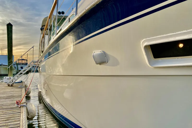 Lazy Livin' Yacht Photos Pics 1971 Hatteras 43 Double Cabin yacht docked at sunset, side view.