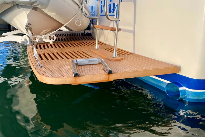 Lazy Livin' Yacht Photos Pics 1971 Hatteras 43 Double Cabin swim platform with ladder, docked on calm water.
