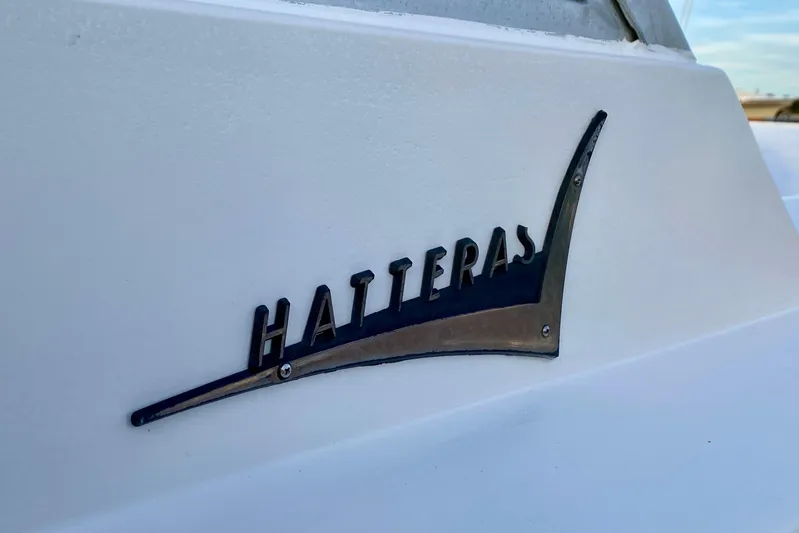 Lazy Livin' Yacht Photos Pics 1971 Hatteras 43 Double Cabin logo on white boat surface.