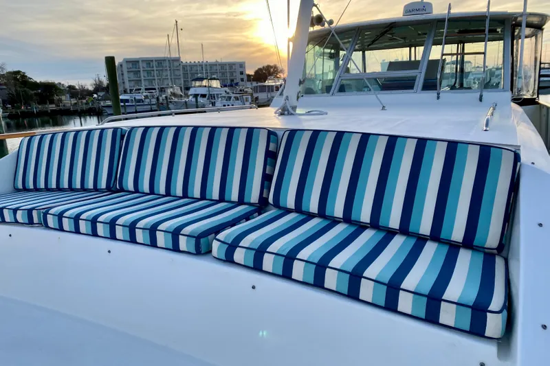 Lazy Livin' Yacht Photos Pics 1971 Hatteras 43 Double Cabin with striped cushions at sunset in marina.