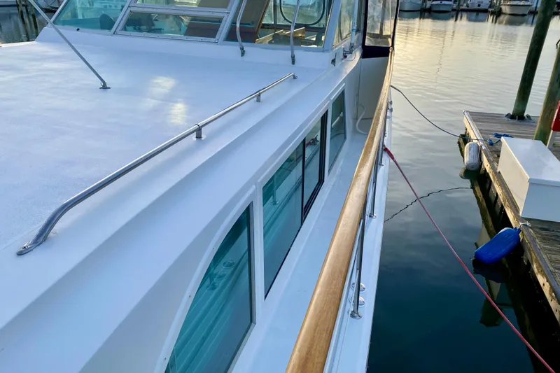 Lazy Livin' Yacht Photos Pics 1971 Hatteras 43 Double Cabin yacht docked at marina, side view.