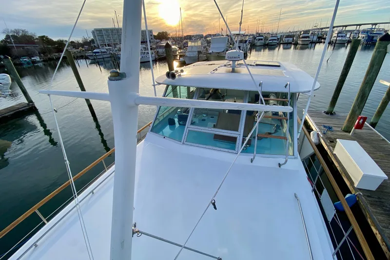 Lazy Livin' Yacht Photos Pics 1971 Hatteras 43 Double Cabin yacht docked at sunset in a marina.
