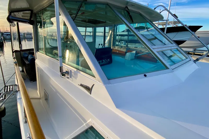 Lazy Livin' Yacht Photos Pics 1971 Hatteras 43 Double Cabin yacht docked at marina, showcasing sleek design and windows.