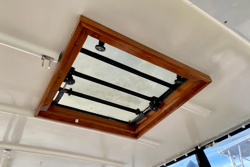 Lazy Livin' Yacht Photos Pics Ceiling hatch of 1971 Hatteras 43 Double Cabin with wooden frame and metal bars.