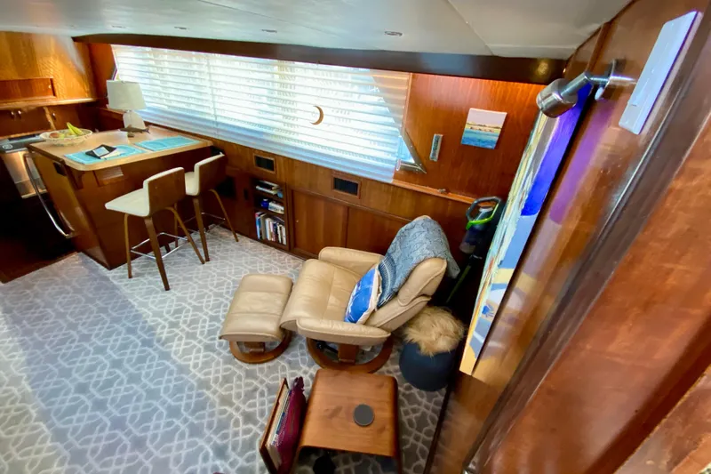 Lazy Livin' Yacht Photos Pics 1971 Hatteras 43 Double Cabin interior with cozy seating and elegant wood finishes.
