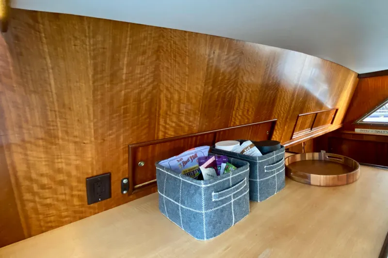 Lazy Livin' Yacht Photos Pics 1971 Hatteras 43 Double Cabin interior with wooden paneling and storage baskets.