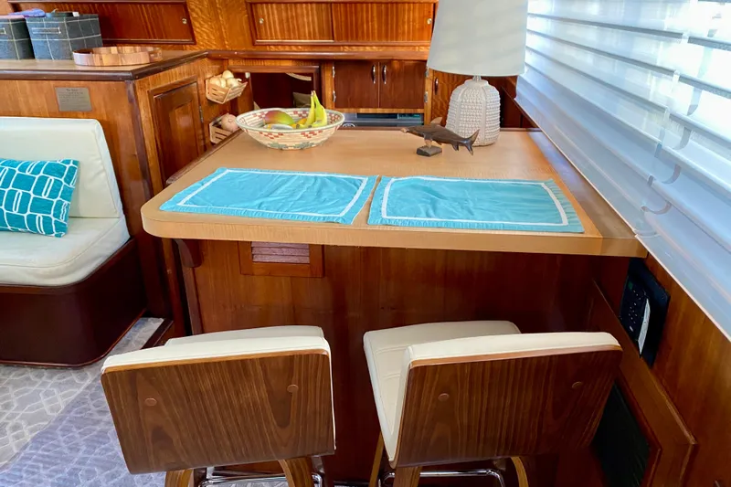 Lazy Livin' Yacht Photos Pics Interior of 1971 Hatteras 43 Double Cabin with wooden decor and seating area.