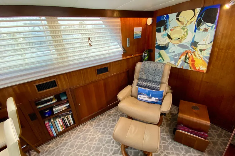 Lazy Livin' Yacht Photos Pics 1971 Hatteras 43 Double Cabin interior with leather chair, artwork, and bookshelf.