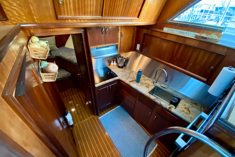 Lazy Livin' Yacht Photos Pics 1971 Hatteras 43 Double Cabin kitchen with wood cabinetry and marble countertops.