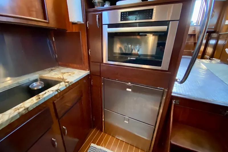 Lazy Livin' Yacht Photos Pics 1971 Hatteras 43 Double Cabin kitchen with modern appliances and wood cabinetry.