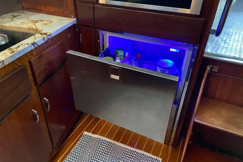 Lazy Livin' Yacht Photos Pics 1971 Hatteras 43 Double Cabin kitchen with open drawer fridge, blue interior light.