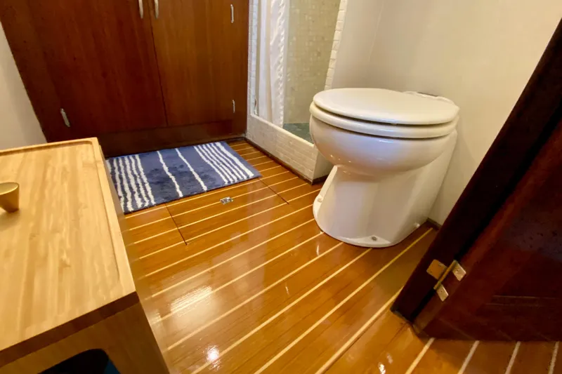 Lazy Livin' Yacht Photos Pics 1971 Hatteras 43 Double Cabin bathroom with wooden flooring and modern fixtures.