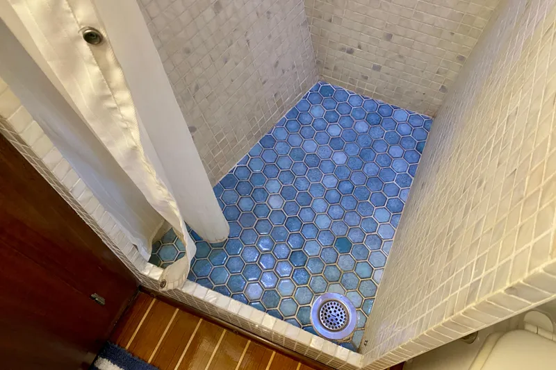 Lazy Livin' Yacht Photos Pics Shower with blue hexagonal tiles in 1971 Hatteras 43 Double Cabin yacht.