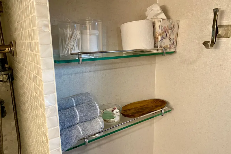 Lazy Livin' Yacht Photos Pics Bathroom shelves on 1971 Hatteras 43 Double Cabin with towels and toiletries.