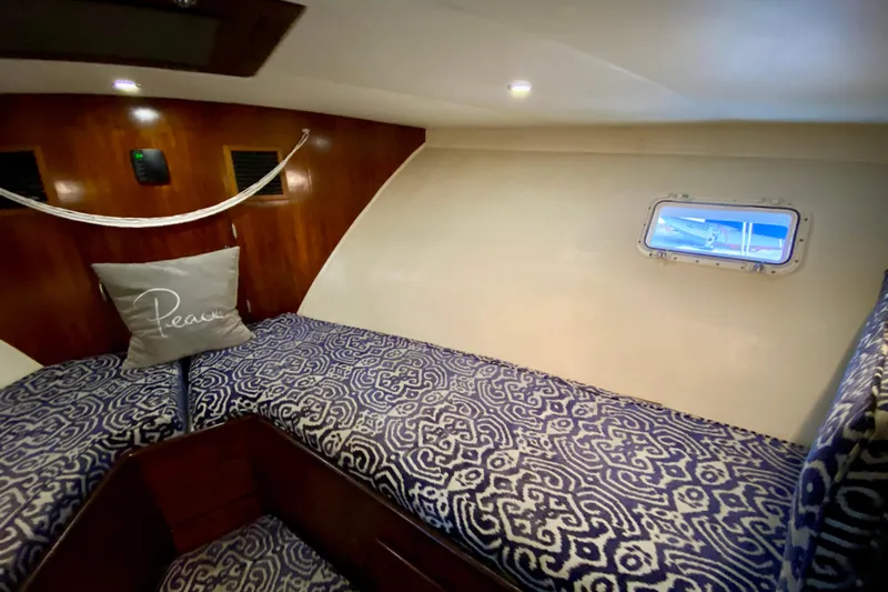 Lazy Livin' Yacht Photos Pics 1971 Hatteras 43 Double Cabin interior with patterned bedding and small window.