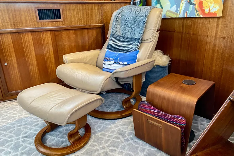 Lazy Livin' Yacht Photos Pics Luxurious leather chair and ottoman in 1971 Hatteras 43 Double Cabin interior.