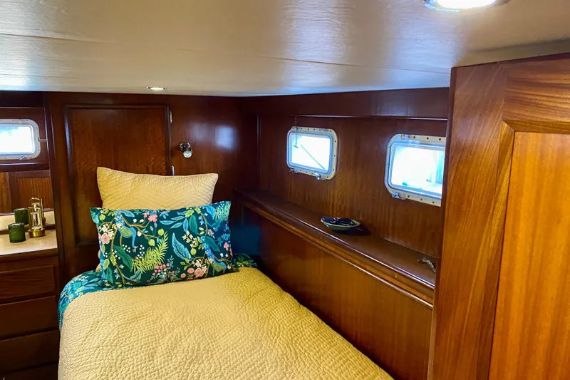Lazy Livin' Yacht Photos Pics 1971 Hatteras 43 Double Cabin interior with cozy bed and wooden paneling.