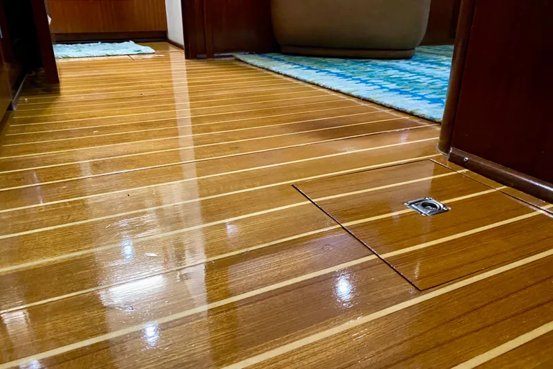 Lazy Livin' Yacht Photos Pics Polished wooden floor inside a 1971 Hatteras 43 Double Cabin yacht.