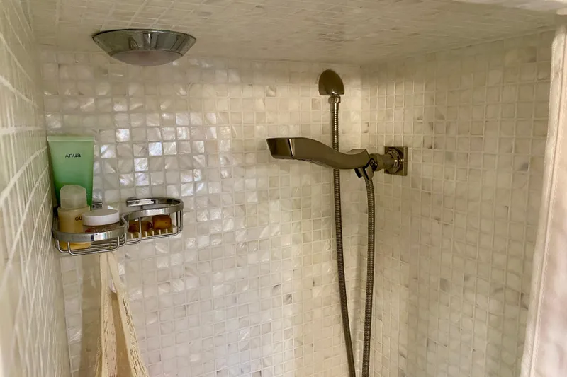 Lazy Livin' Yacht Photos Pics Shower area in 1971 Hatteras 43 Double Cabin with tiled walls and toiletries.