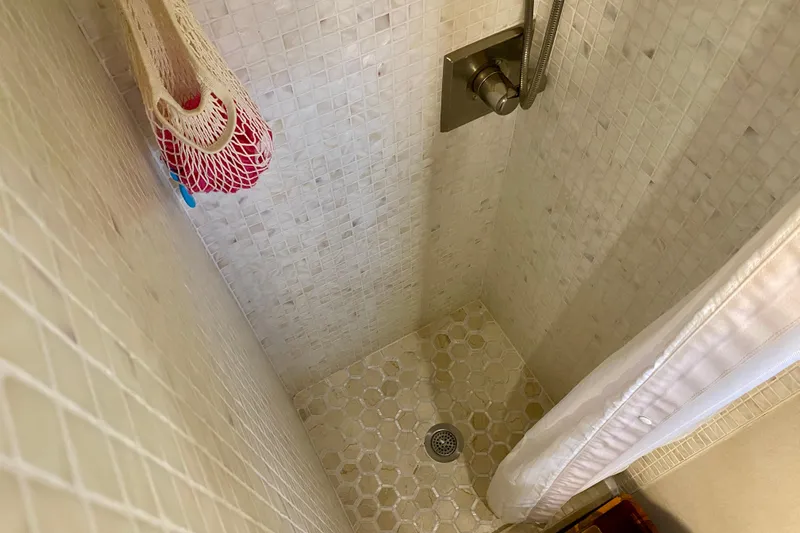 Lazy Livin' Yacht Photos Pics Shower area in 1971 Hatteras 43 Double Cabin yacht with tiled walls and floor.