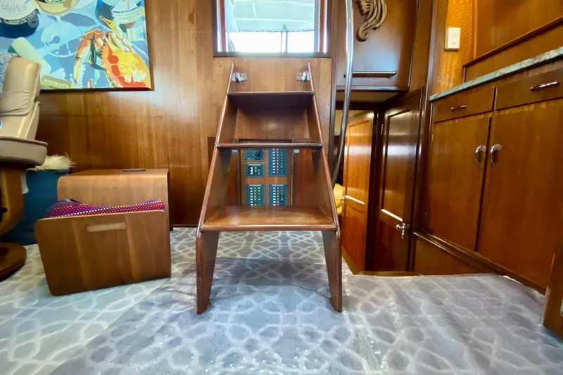 Lazy Livin' Yacht Photos Pics Interior of 1971 Hatteras 43 Double Cabin with wooden stairs and nautical decor.