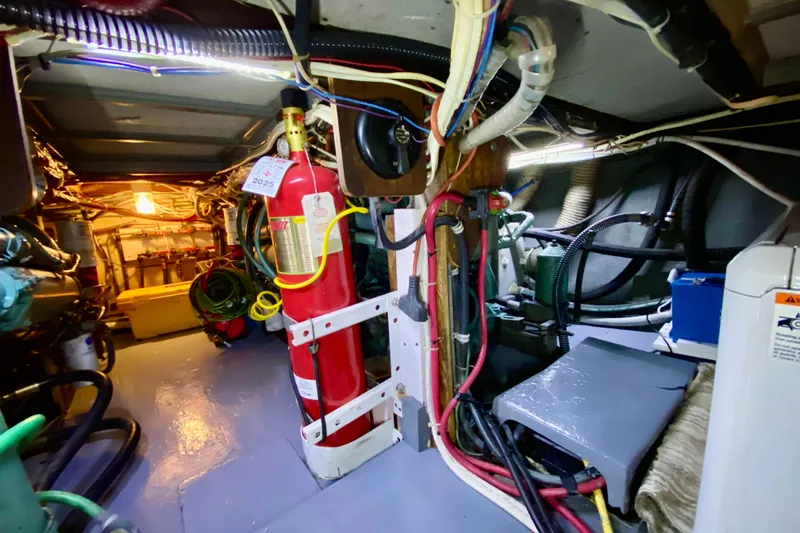 Lazy Livin' Yacht Photos Pics Engine room of a 1971 Hatteras 43 Double Cabin with fire extinguisher and wiring.