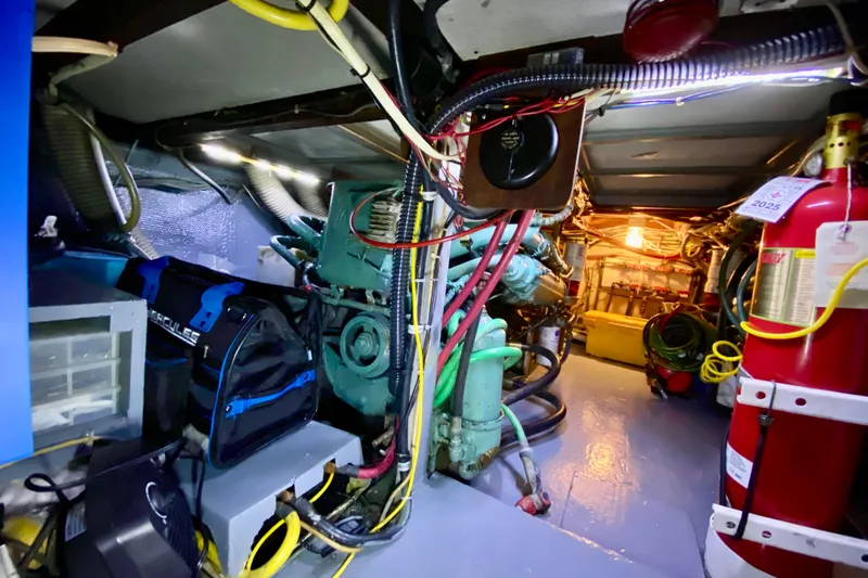 Lazy Livin' Yacht Photos Pics Engine room of a 1971 Hatteras 43 Double Cabin with visible machinery and equipment.