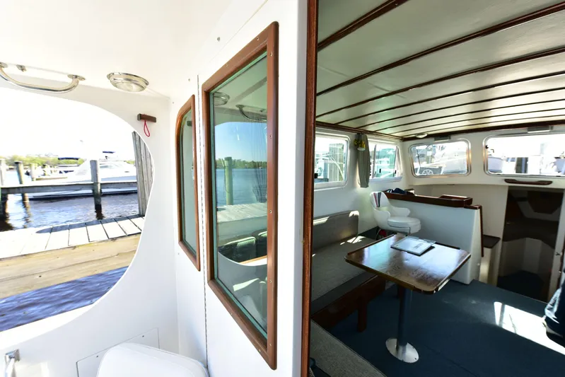 About Time Yacht Photos Pics Interior of 1998 Duffy 35 Downeast Cruiser with wooden accents and waterfront view.