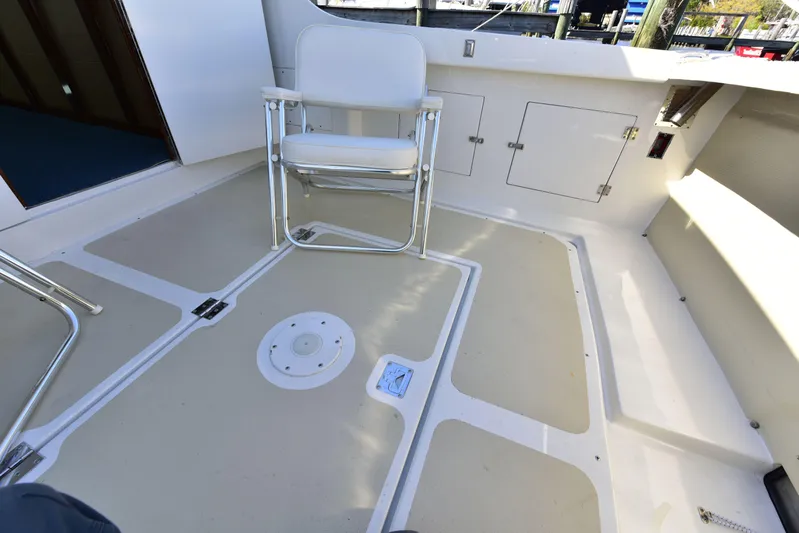 About Time Yacht Photos Pics 1998 Duffy 35 Downeast Cruiser deck with chair and storage compartments.