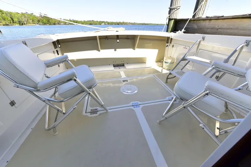 About Time Yacht Photos Pics 1998 Duffy 35 Downeast Cruiser deck with seating, overlooking serene water.