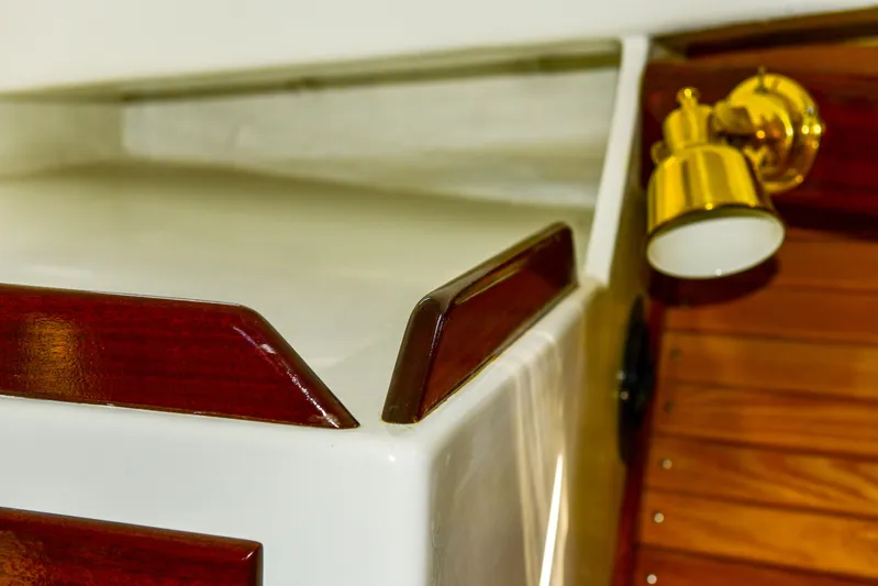 About Time Yacht Photos Pics Interior detail of 1998 Duffy 35 Downeast Cruiser with wood trim and brass light fixture.