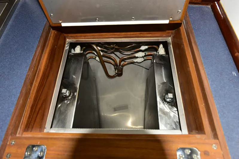 About Time Yacht Photos Pics Engine compartment of 1998 Duffy 35 Downeast Cruiser with visible wiring and metal components.