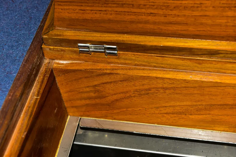 About Time Yacht Photos Pics Wooden interior detail of a 1998 Duffy 35 Downeast Cruiser, featuring a metal hinge.