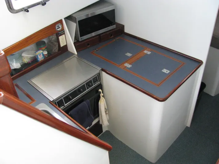 About Time Yacht Photos Pics Compact kitchen area in a 1998 Duffy 35 Downeast Cruiser boat.