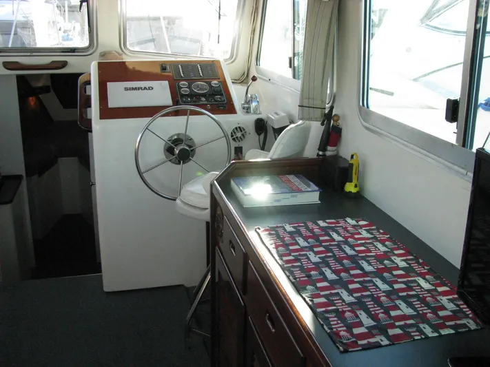 About Time Yacht Photos Pics Interior of 1998 Duffy 35 Downeast Cruiser with steering wheel and control panel.