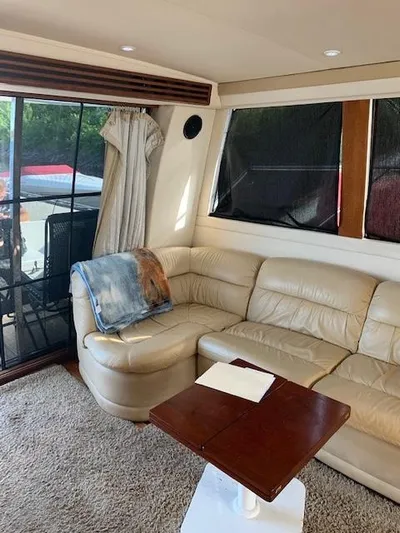  Yacht Photos Pics Interior of 1999 Carver 450 Voyager yacht with beige leather seating and wooden table.