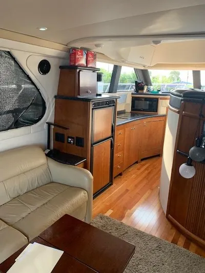  Yacht Photos Pics Interior of 1999 Carver 450 Voyager yacht with kitchen and seating area.