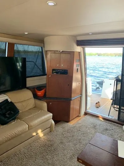  Yacht Photos Pics Interior of 1999 Carver 450 Voyager yacht with beige sofa and lake view.