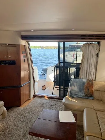  Yacht Photos Pics Interior of 1999 Carver 450 Voyager yacht with lake view through sliding doors.